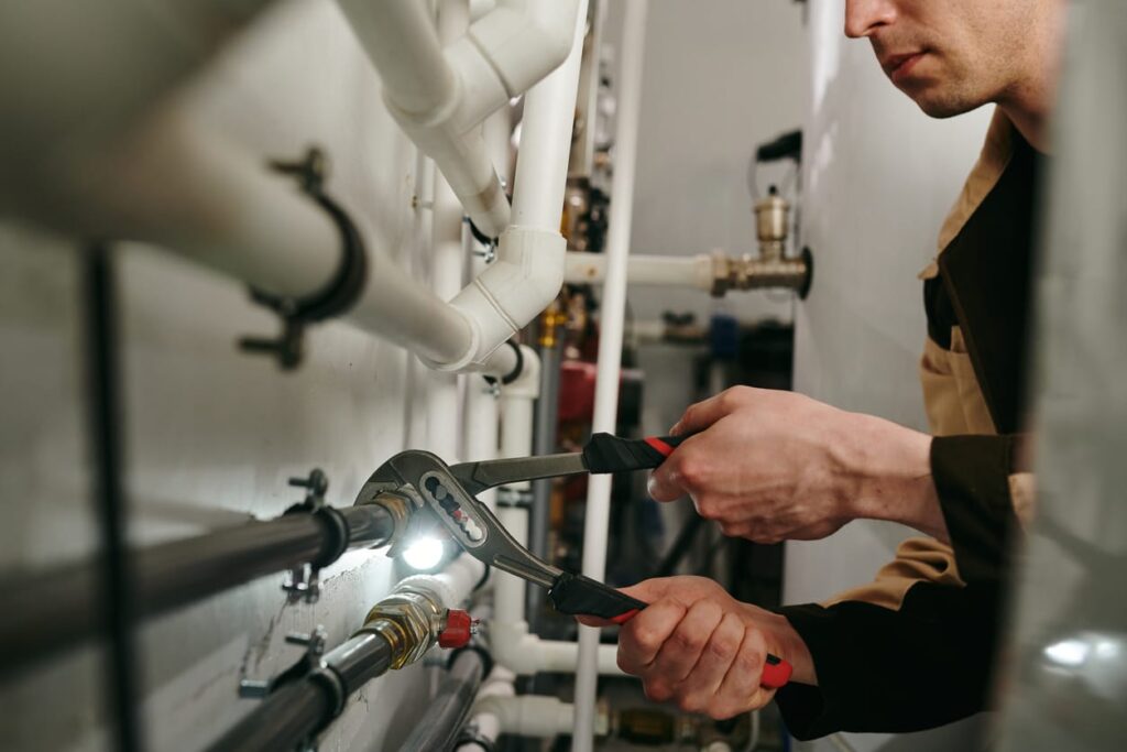 Plumbers maintaining commercial plumbing pipes in Monroeville
