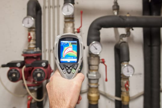 Plumber using a thermal imaging camera to inspect pipes in Monroeville